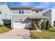 Charming two-story home with a well-manicured lawn, attached garage, and inviting front porch at 905 Moye Dr, Raleigh, NC 27606