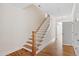 Bright foyer featuring hardwood floors, a staircase with white banisters, and ample natural light at 905 Moye Dr, Raleigh, NC 27606