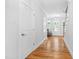 Hallway with wood floors and doors to the rooms of the home at 905 Moye Dr, Raleigh, NC 27606