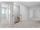 Second floor hallway with carpet floors and staircase to third floor at 905 Moye Dr, Raleigh, NC 27606