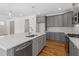 A kitchen with gray cabinets, a center island with a sink, and stainless steel appliances at 905 Moye Dr, Raleigh, NC 27606