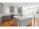 Bright kitchen with gray cabinets, stainless steel appliances, and a white countertop island at 905 Moye Dr, Raleigh, NC 27606