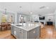Bright kitchen with a large island, stainless steel appliances, a dining area, and view into the living room at 905 Moye Dr, Raleigh, NC 27606