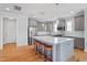 Bright, updated kitchen featuring grey cabinetry, a subway tile backsplash, and a center island with barstool seating at 905 Moye Dr, Raleigh, NC 27606