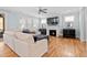 Spacious living room featuring a cozy fireplace, lots of windows, and plush seating at 905 Moye Dr, Raleigh, NC 27606