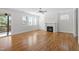 Bright and airy living room with hardwood floors, a ceiling fan, and a cozy fireplace at 905 Moye Dr, Raleigh, NC 27606