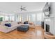 Spacious living room with fireplace, lots of windows, hardwood floors, and comfortable seating at 905 Moye Dr, Raleigh, NC 27606