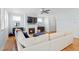 Cozy living room with hardwood floors, large windows, plush sofa, and a fireplace at 905 Moye Dr, Raleigh, NC 27606