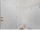 Mudroom featuring a bench with hooks and a white door, offering a clean transition space at 905 Moye Dr, Raleigh, NC 27606