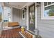 Inviting front porch featuring wood flooring, swing, and decorative accents at 905 Moye Dr, Raleigh, NC 27606
