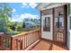 Relaxing screened porch, boasting views of neighboring houses, a well-manicured lawn, and a clear, sunny sky at 905 Moye Dr, Raleigh, NC 27606
