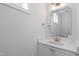 Elegant powder room with a modern vanity, quartz countertop, and decorative mirror at 905 Moye Dr, Raleigh, NC 27606