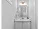 Elegant powder room with a modern vanity, stylish mirror, and a clean, minimalist design at 905 Moye Dr, Raleigh, NC 27606