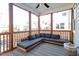 Relaxing screened porch with a comfortable sectional and patterned rug at 905 Moye Dr, Raleigh, NC 27606