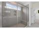 Modern bathroom shower featuring tiled walls, glass enclosure, and a built-in bench at 905 Moye Dr, Raleigh, NC 27606