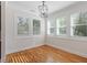 A sunroom with hardwood floors, white walls, plantation shutters, and natural light at 905 Moye Dr, Raleigh, NC 27606