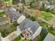 Overhead view of a two-story home showcasing its backyard and proximity to a golf course at 9220 Meadow Mist Ct, Raleigh, NC 27617