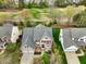 Aerial view of a brick house showcasing the landscaping, multi-car garage, and neighborhood at 9220 Meadow Mist Ct, Raleigh, NC 27617