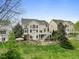 Rear elevation showing spacious backyard with stone gazebo, patio, and lush lawn at 9220 Meadow Mist Ct, Raleigh, NC 27617