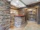 Finished basement featuring a stone bar with wood countertop and decorative wood and stone design at 9220 Meadow Mist Ct, Raleigh, NC 27617