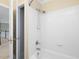 Bathtub with a shower head and white tile walls at 9220 Meadow Mist Ct, Raleigh, NC 27617