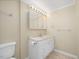 Bright bathroom features a white vanity, ample lighting, and tile floors at 9220 Meadow Mist Ct, Raleigh, NC 27617