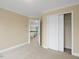 Bright bedroom with carpet, doors, and base molding throughout the space at 9220 Meadow Mist Ct, Raleigh, NC 27617