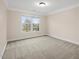 Spacious bedroom featuring neutral carpet and walls, and bright natural light at 9220 Meadow Mist Ct, Raleigh, NC 27617