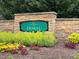 Attractive 'Village of Doral' entrance sign surrounded by vibrant flowerbeds and manicured landscaping at 9220 Meadow Mist Ct, Raleigh, NC 27617