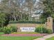 Elegant 'Brier Creek Country Club' entrance sign surrounded by lush greenery and colorful flowerbeds at 9220 Meadow Mist Ct, Raleigh, NC 27617