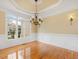 Dining area with natural light, decorative lighting, wainscoting, and hardwood floors at 9220 Meadow Mist Ct, Raleigh, NC 27617