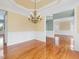 Dining room with hardwood floors, decorative lighting, view into foyer and additional rooms at 9220 Meadow Mist Ct, Raleigh, NC 27617
