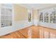 Dining room with natural light from windows, wainscoting, and hardwood flooring at 9220 Meadow Mist Ct, Raleigh, NC 27617