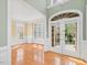 Bright foyer featuring hardwood floors, double doors and natural light, plus views into an adjacent room at 9220 Meadow Mist Ct, Raleigh, NC 27617