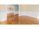 Foyer with hardwood floors and view into dining room with chandelier and wainscoting at 9220 Meadow Mist Ct, Raleigh, NC 27617