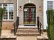 Stately brick home showcasing a grand front entrance with elegant doors and manicured landscaping at 9220 Meadow Mist Ct, Raleigh, NC 27617