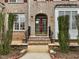 Beautiful brick home featuring a classic front door with decorative sidelights and manicured greenery at 9220 Meadow Mist Ct, Raleigh, NC 27617