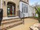 Beautiful front entrance with an elegant door, transom window, and brick steps leading to a welcoming patio at 9220 Meadow Mist Ct, Raleigh, NC 27617