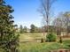 Beautiful view of the golf course from the backyard with mature trees and lush greenery at 9220 Meadow Mist Ct, Raleigh, NC 27617