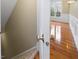 Inviting hallway leading to a room featuring hardwood flooring and white wainscoting at 9220 Meadow Mist Ct, Raleigh, NC 27617
