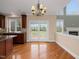 Eat-in kitchen with granite countertops, a charming breakfast nook, and views of the backyard at 9220 Meadow Mist Ct, Raleigh, NC 27617