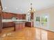 Bright eat-in kitchen featuring an island, granite countertops, and stainless steel appliances at 9220 Meadow Mist Ct, Raleigh, NC 27617