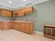 Functional kitchenette features wood cabinets, stainless steel sink, and neutral countertops at 9220 Meadow Mist Ct, Raleigh, NC 27617