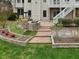 Backyard landscaping featuring garden beds and stone-paved pathways and patio at 9220 Meadow Mist Ct, Raleigh, NC 27617