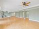 Open concept living room features hardwood floors, a ceiling fan, and neutral walls at 9220 Meadow Mist Ct, Raleigh, NC 27617