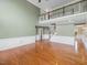 Spacious living room with fireplace, hardwood floors, and a view of the upper-level landing at 9220 Meadow Mist Ct, Raleigh, NC 27617