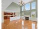 Open living area featuring a fireplace, many windows, and hardwood floors at 9220 Meadow Mist Ct, Raleigh, NC 27617