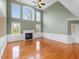 Open living area featuring a fireplace, many windows and hardwood floors at 9220 Meadow Mist Ct, Raleigh, NC 27617