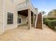 Rear view of home featuring outdoor patio and stairs to upper level deck at 9220 Meadow Mist Ct, Raleigh, NC 27617