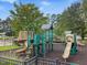 Neighborhood playground with multiple slides, climbing structures, and a safety-surfaced ground at 9220 Meadow Mist Ct, Raleigh, NC 27617